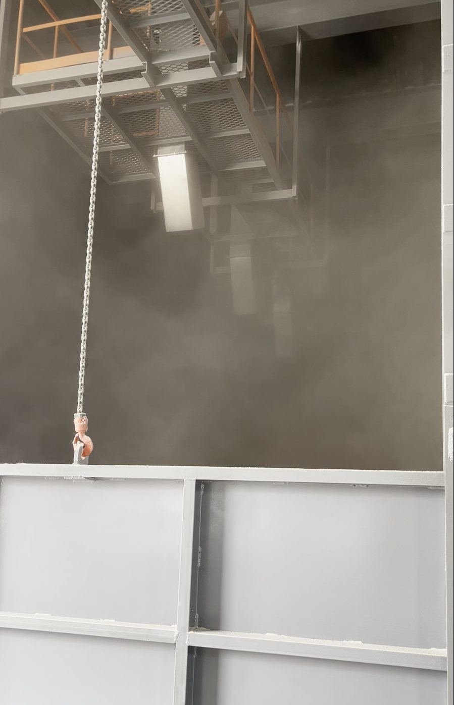 A storage bay filled with airborne dust during maize intake through a bare chute