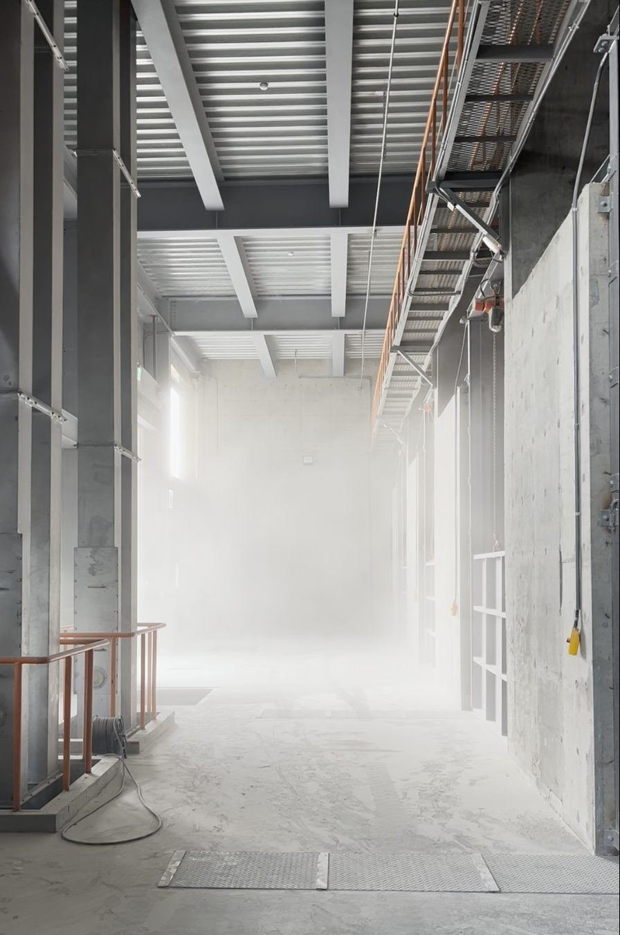 The loading corridor during maize intake, dust obscuring the length of the building