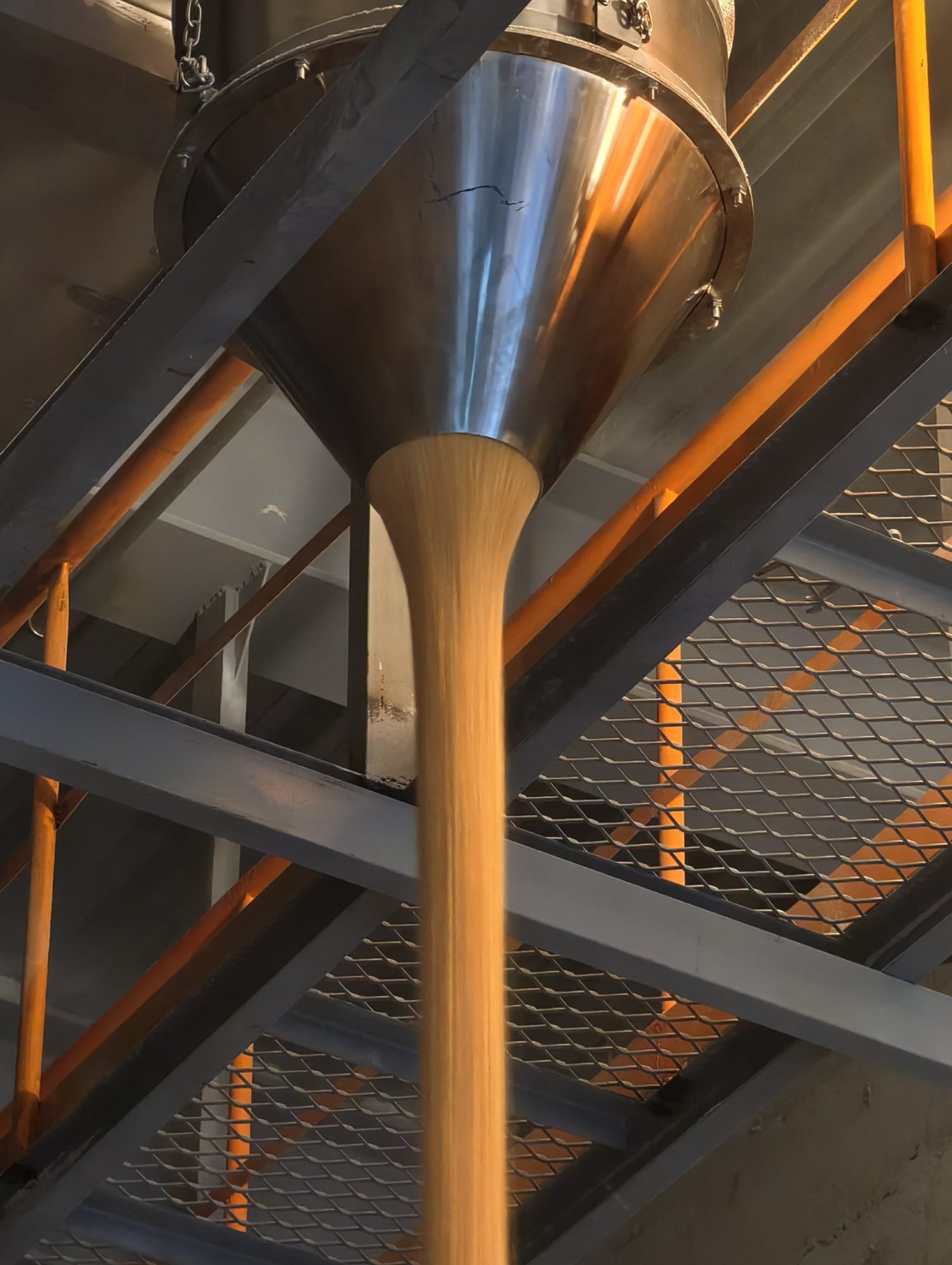 DustCone hopper discharging grain as a dense solid column through a walkway