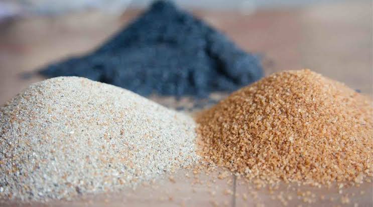 Piles of silica sand and mineral aggregate